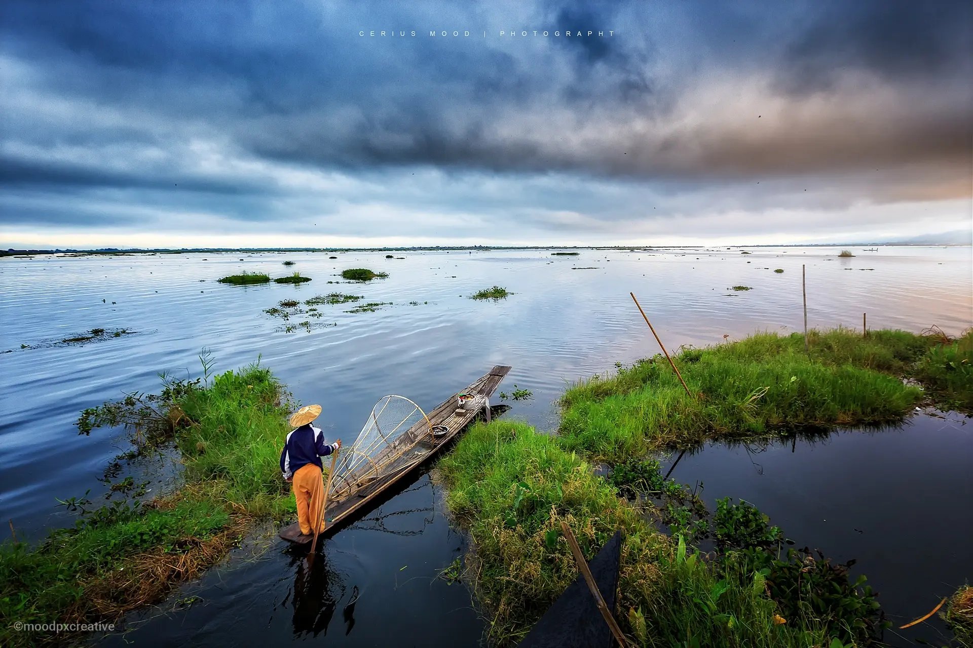 A leg rower on Inle Lake is starting his fishing work in the early morning.